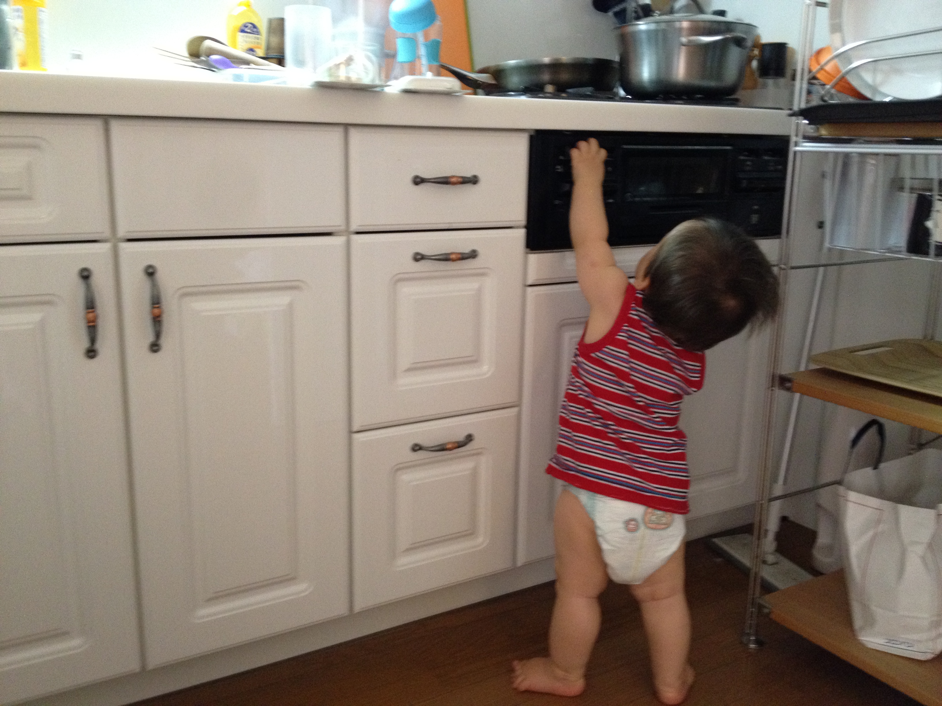 Baby-touching-the-stove-buttons