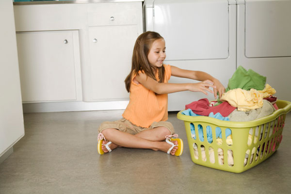 Household-chores-School-aged-girl-folding-laundry_i9s441